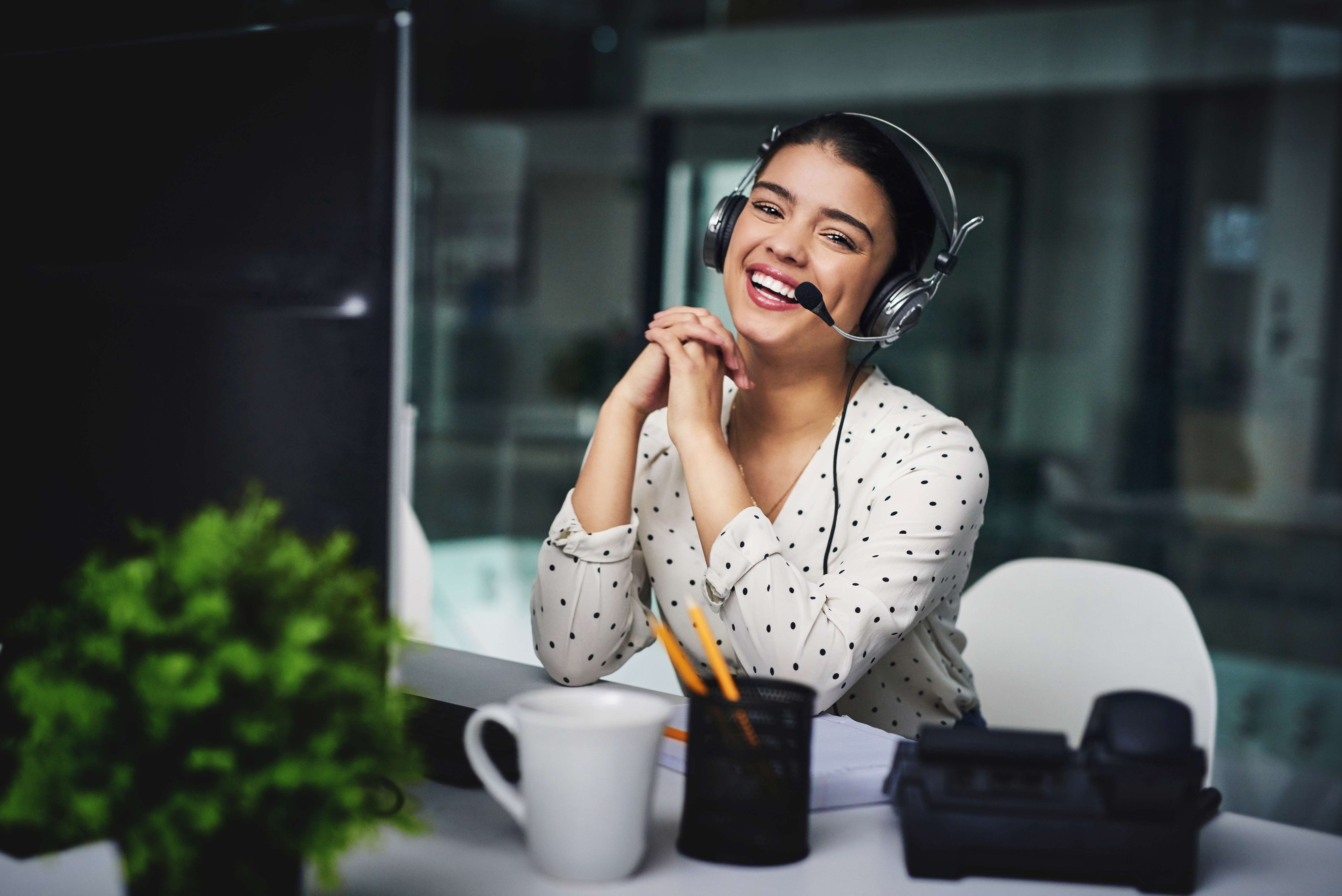 SecureEVAs virtual assistant of the month with headset at her desk
